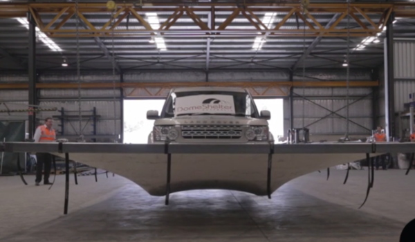 Large vehicle driving on a fabric dome structure to test strength